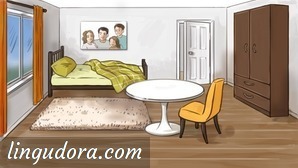 In the middle of a room there is a round table and a yellow chair beside it. The bed is in the back of the room. Above, on the wall, there is an image depicting a family. To the right of the bed a door is slightly opened. In front of the bed there is a carpet. Along the right wall there is a big brown wardrobe and on the opposite side a window with orange curtains is shown.